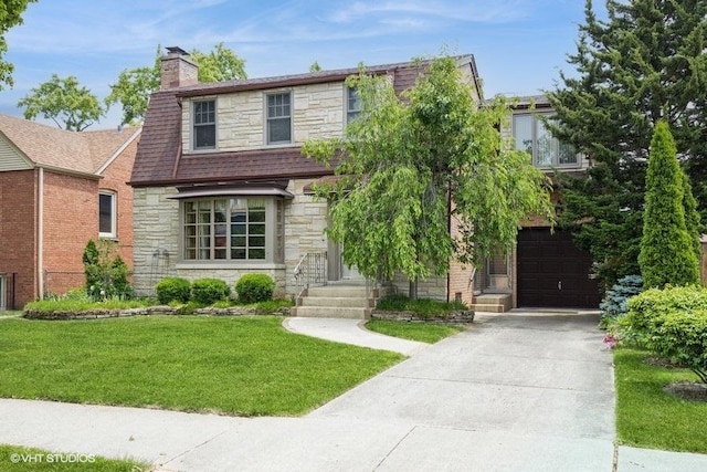 1707 N 78th Ave, Elmwood Park, IL 60707 - view of front of home with stone siding, driveway, a front lawn, a chimney, and an attached garage