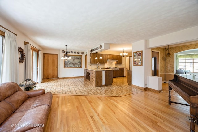 1707 N 78th Ave, Elmwood Park, IL 60707 - living area with a chandelier and light wood-style floors