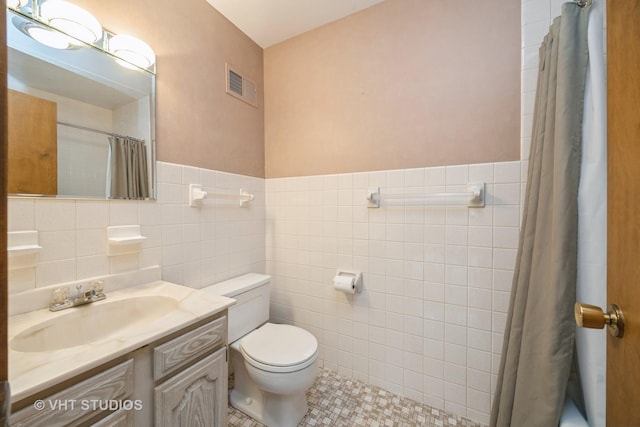 1707 N 78th Ave, Elmwood Park, IL 60707 - full bath with tile walls, vanity, and tile patterned flooring