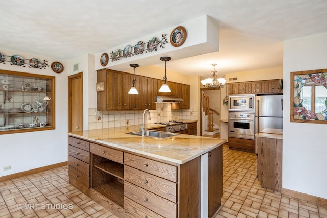 1707 N 78th Ave, Elmwood Park, IL 60707 - kitchen featuring appliances with stainless steel finishes, brick patterned flooring, brown cabinets, decorative backsplash, and under cabinet range hood