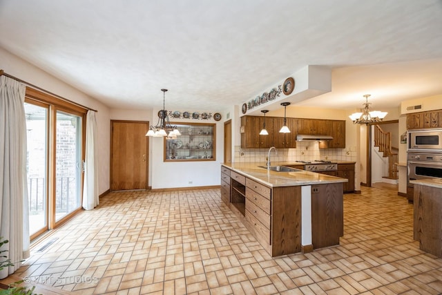1707 N 78th Ave, Elmwood Park, IL 60707 - kitchen featuring a chandelier, a peninsula, stainless steel appliances, and plenty of natural light