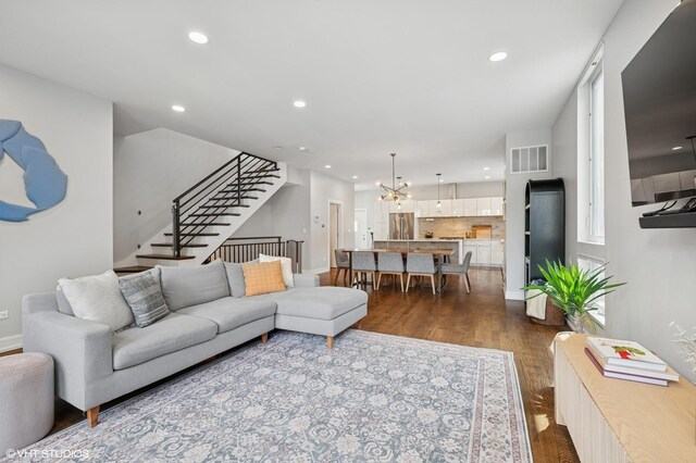 1633 N Saint Louis Ave, Chicago, IL 60647 - living room featuring stairs, recessed lighting, dark wood finished floors, and a chandelier