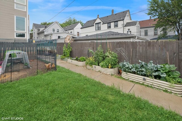 1633 N Saint Louis Ave, Chicago, IL 60647 - fenced backyard featuring a vegetable garden and a residential view