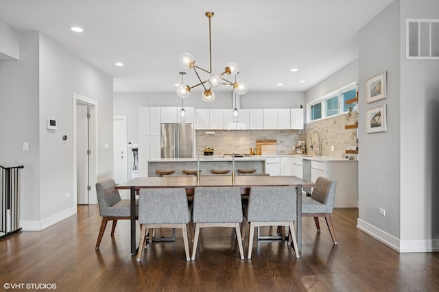 1633 N Saint Louis Ave, Chicago, IL 60647 - dining area featuring dark wood-style flooring, a chandelier, and recessed lighting
