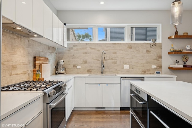 1633 N Saint Louis Ave, Chicago, IL 60647 - kitchen featuring stainless steel appliances, open shelves, backsplash, white cabinets, and recessed lighting