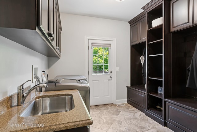 3136 Kewanee Ln, Naperville, IL 60564 - washroom featuring washing machine and dryer, cabinet space, and light stone finish floors