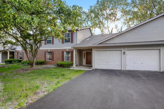 1022 Chaucer Ct Unit B, Elgin, IL 60120 - view of front of house featuring an attached garage, asphalt driveway, brick siding, and a front yard