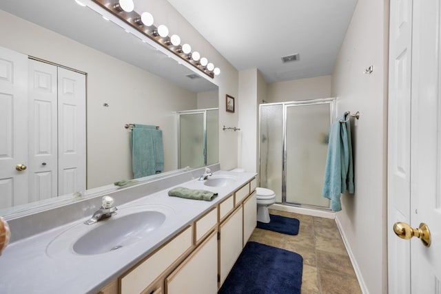 1022 Chaucer Ct Unit B, Elgin, IL 60120 - bathroom featuring a closet, double vanity, and a stall shower