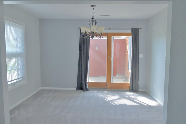 521 Coventry Ln Unit 16, Crystal Lake, IL 60014 - empty room with a chandelier, carpet floors, plenty of natural light, and baseboards