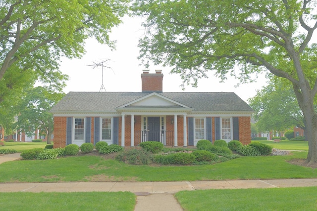 521 Coventry Ln Unit 16, Crystal Lake, IL 60014 - neoclassical home with a chimney, a front lawn, and brick siding