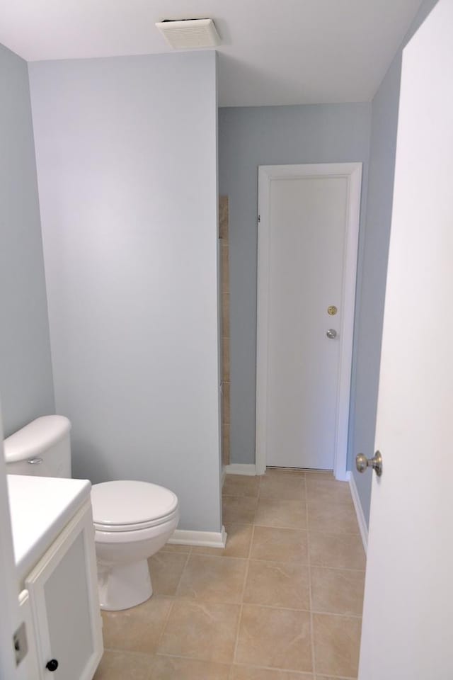 521 Coventry Ln Unit 16, Crystal Lake, IL 60014 - bathroom with vanity, toilet, tile patterned floors, baseboards, and a shower