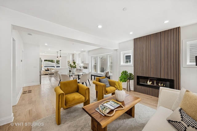 920 Hayes Ave, Oak Park, IL 60302 - living room with light wood-style floors, recessed lighting, and a glass covered fireplace