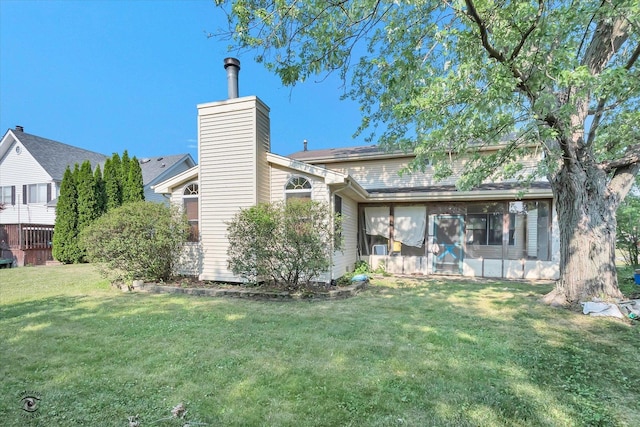 13706 W Cedarbend Dr, Homer Glen, IL 60491 - back of house featuring a sunroom, a chimney, and a lawn