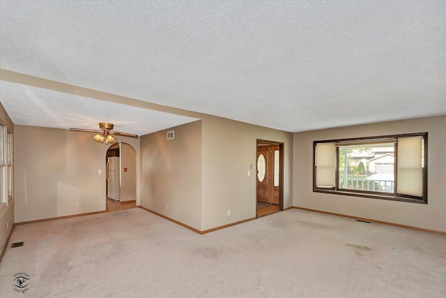 13706 W Cedarbend Dr, Homer Glen, IL 60491 - carpeted spare room with a textured ceiling, arched walkways, and ceiling fan