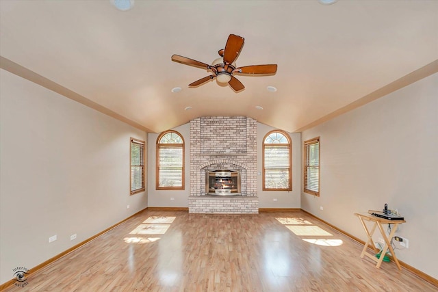 13706 W Cedarbend Dr, Homer Glen, IL 60491 - unfurnished living room featuring lofted ceiling, healthy amount of natural light, wood finished floors, ceiling fan, and a brick fireplace