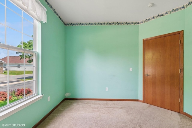 715 S Wellston Ln, Romeoville, IL 60446 - carpeted empty room with healthy amount of natural light, baseboards, and a smoke detector