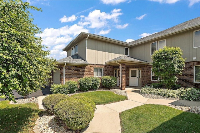 15031 Mayo Dr Unit 19D, Orland Park, IL 60462 - traditional home with brick siding, a front lawn, and a shingled roof