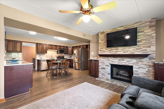 15031 Mayo Dr Unit 19D, Orland Park, IL 60462 - living area with dark wood-type flooring, a ceiling fan, and a fireplace