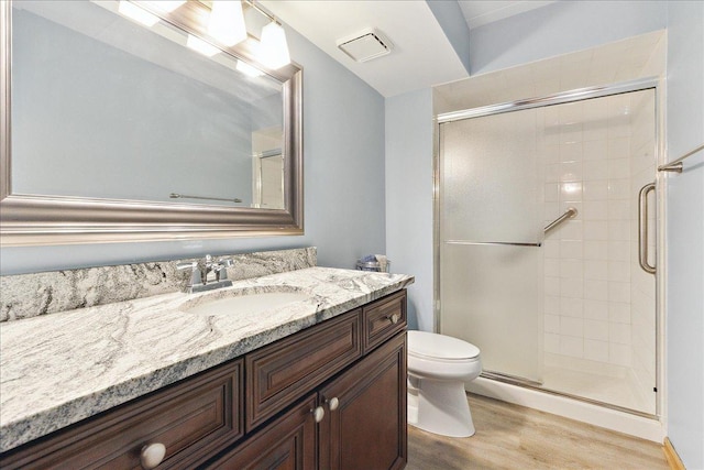 15031 Mayo Dr Unit 19D, Orland Park, IL 60462 - bathroom featuring wood finished floors, vanity, a shower stall, and toilet