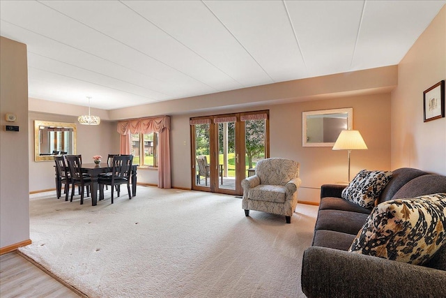 15031 Mayo Dr Unit 19D, Orland Park, IL 60462 - carpeted living area with baseboards and a chandelier