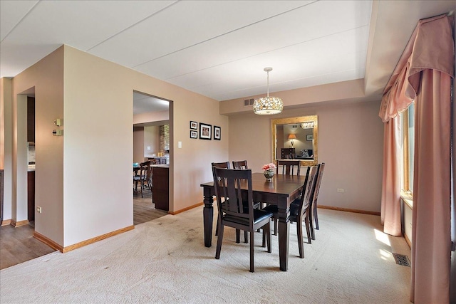 15031 Mayo Dr Unit 19D, Orland Park, IL 60462 - dining space with light colored carpet, baseboards, and a chandelier