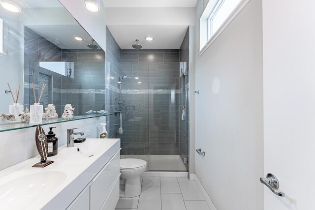 2143 W 19th St Unit 3, Chicago, IL 60608 - bathroom with a shower stall, double vanity, toilet, and baseboards