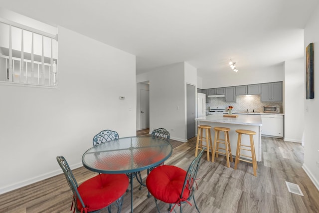 2812 Sun Valley Dr, Plainfield, IL 60586 - dining room featuring light wood-type flooring and baseboards