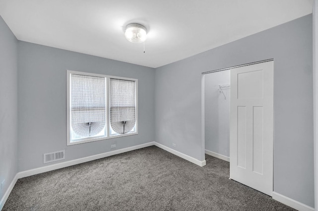 7825 S St Lawrence Ave, Chicago, IL 60619 - spare room featuring dark colored carpet and baseboards