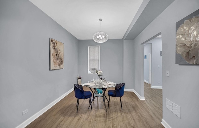 7825 S St Lawrence Ave, Chicago, IL 60619 - dining area featuring a chandelier and wood finished floors