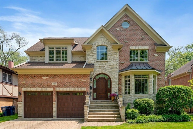 320 Vista Dr, Wilmette, IL 60091 - view of front facade featuring stone siding, decorative driveway, a garage, and a shingled roof