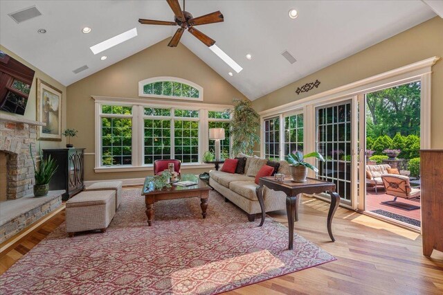 320 Vista Dr, Wilmette, IL 60091 - living room with a skylight, high vaulted ceiling, wood finished floors, healthy amount of natural light, and recessed lighting