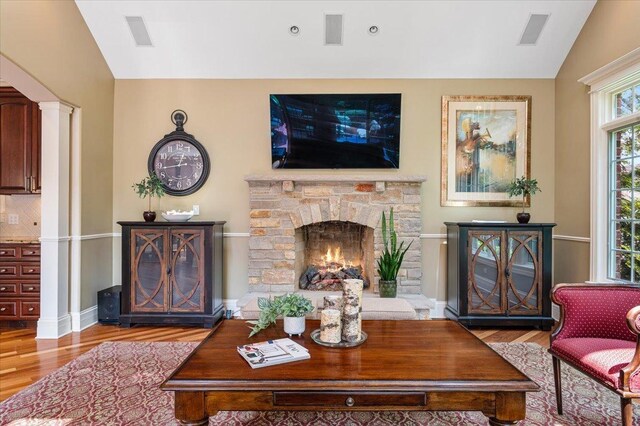 320 Vista Dr, Wilmette, IL 60091 - living room featuring wood finished floors, lofted ceiling, a fireplace, and ornate columns