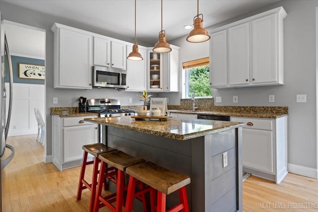 0S587 Grengs Ln, Geneva, IL 60134 - kitchen with appliances with stainless steel finishes, light wood-type flooring, white cabinetry, dark stone countertops, and recessed lighting