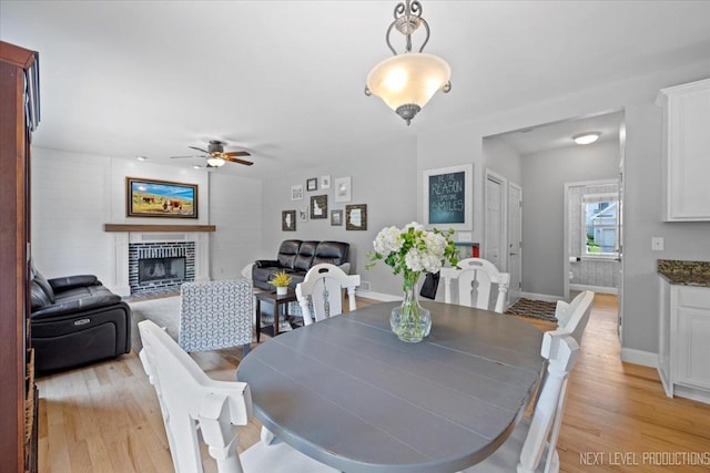 0S587 Grengs Ln, Geneva, IL 60134 - dining space with ceiling fan, light wood-type flooring, and a fireplace