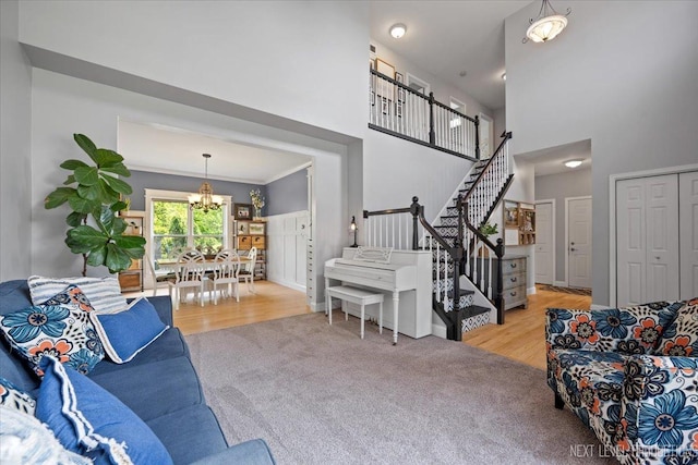 0S587 Grengs Ln, Geneva, IL 60134 - living room with a chandelier, a high ceiling, stairs, wood finished floors, and carpet floors