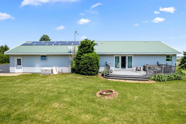 2365 Richardson Rd, West Brooklyn, IL 61378 - rear view of house featuring a deck, metal roof, and a lawn