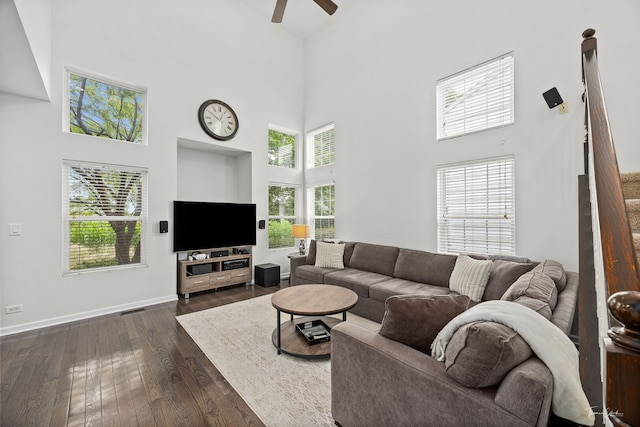7015 Clearwater Dr Unit 7015, Plainfield, IL 60586 - living room featuring a towering ceiling, a ceiling fan, plenty of natural light, and dark wood finished floors
