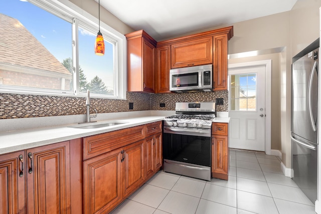 3408 S 58th Ave, Cicero, IL 60804 - kitchen with stainless steel appliances, light countertops, backsplash, and brown cabinets