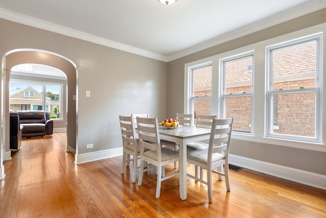 3408 S 58th Ave, Cicero, IL 60804 - dining room featuring light wood-type flooring, ornamental molding, and arched walkways