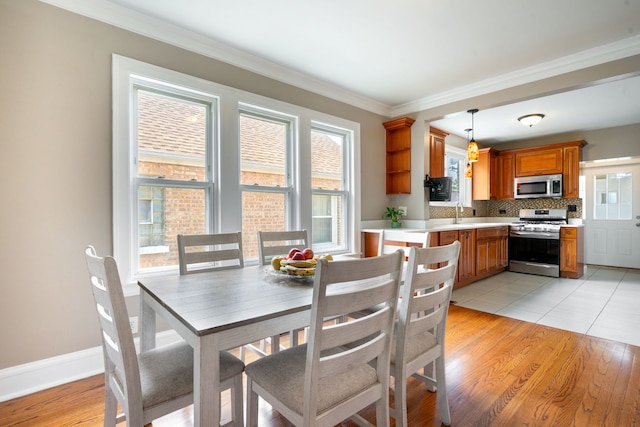 3408 S 58th Ave, Cicero, IL 60804 - dining space featuring crown molding and light wood-style floors