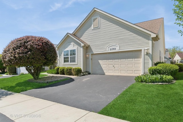 21359 W Sycamore Dr, Plainfield, IL 60544 - view of front facade with asphalt driveway, a garage, a front lawn, and roof with shingles