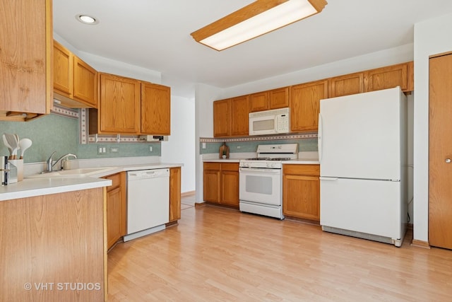 21359 W Sycamore Dr, Plainfield, IL 60544 - kitchen featuring white appliances, a sink, backsplash, light countertops, and light wood-type flooring