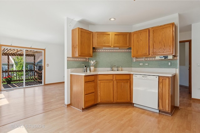 21359 W Sycamore Dr, Plainfield, IL 60544 - kitchen featuring dishwasher, a sink, light wood-style flooring, light countertops, and tasteful backsplash