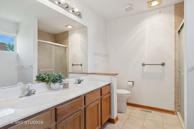 21359 W Sycamore Dr, Plainfield, IL 60544 - full bath featuring a stall shower, toilet, double vanity, tile patterned floors, and baseboards
