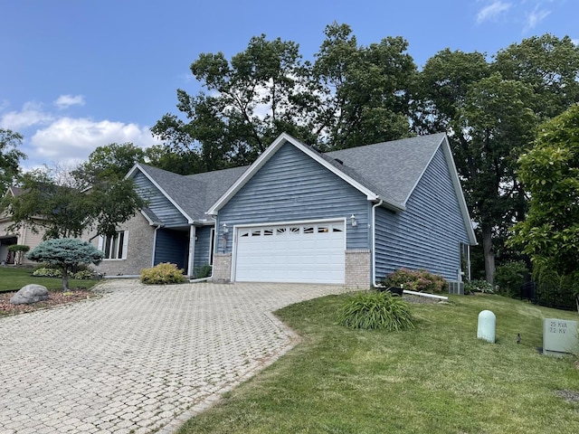 2500 Cherie Ln, Ottawa, IL 61350 - ranch-style home with an attached garage, decorative driveway, a front lawn, brick siding, and a shingled roof