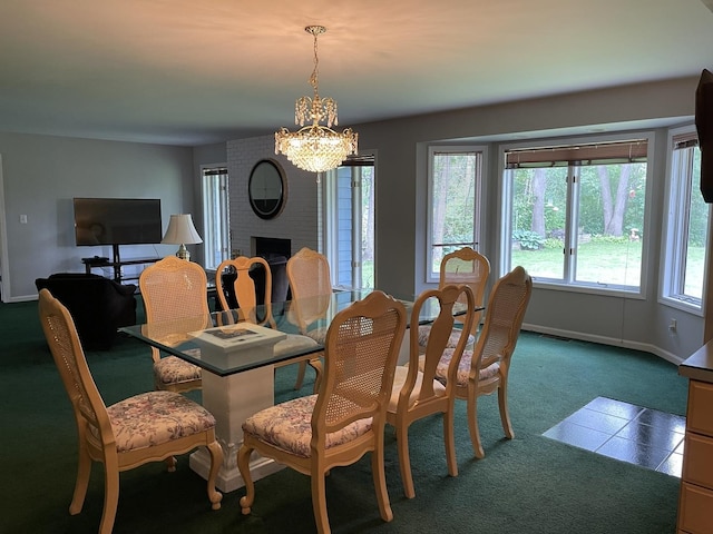 2500 Cherie Ln, Ottawa, IL 61350 - carpeted dining room featuring a chandelier, a fireplace, and baseboards