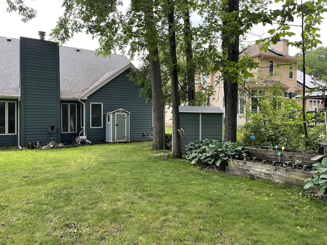 2500 Cherie Ln, Ottawa, IL 61350 - back of property featuring a yard, a vegetable garden, a shingled roof, and a chimney