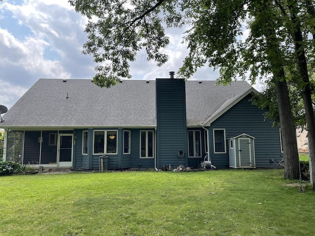 2500 Cherie Ln, Ottawa, IL 61350 - back of property featuring a chimney, a yard, a shingled roof, and a sunroom