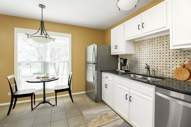736 73rd St Unit 0, Downers Grove, IL 60516 - kitchen with appliances with stainless steel finishes, backsplash, white cabinetry, dark stone countertops, and decorative light fixtures