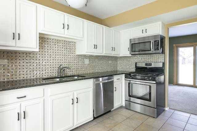 736 73rd St Unit 0, Downers Grove, IL 60516 - kitchen featuring appliances with stainless steel finishes, white cabinetry, dark stone counters, light tile patterned flooring, and tasteful backsplash
